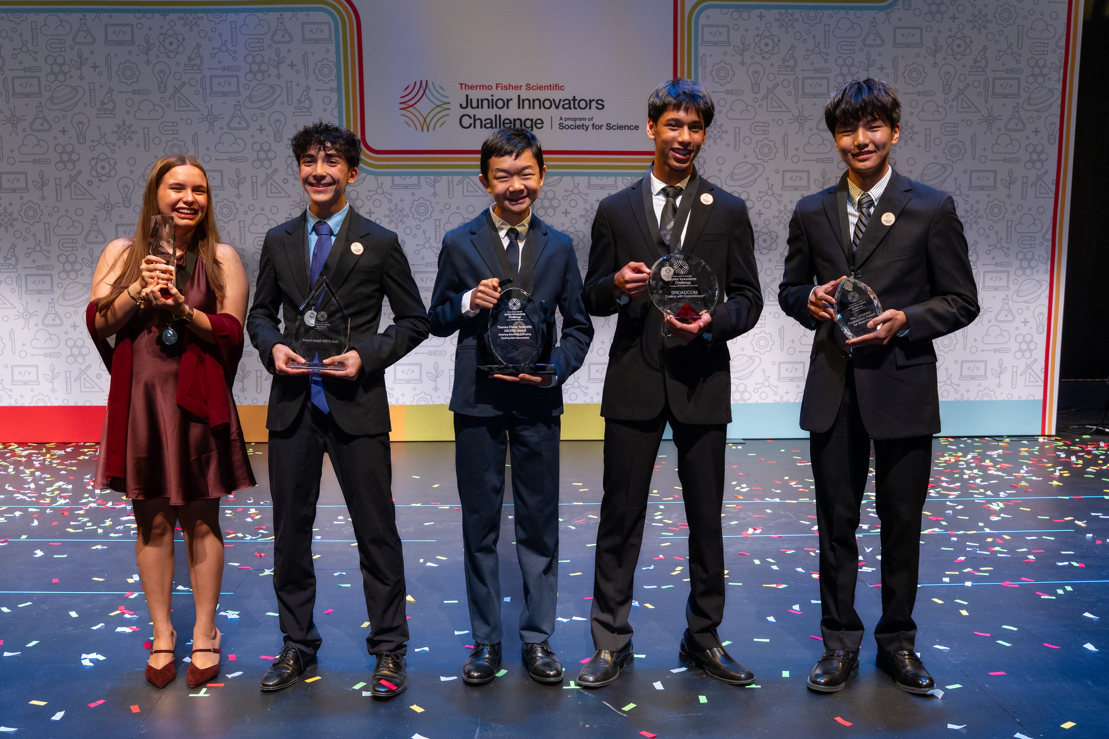 Akhil Nagori standing with other Junior Innovators Challenge student finalists on stage